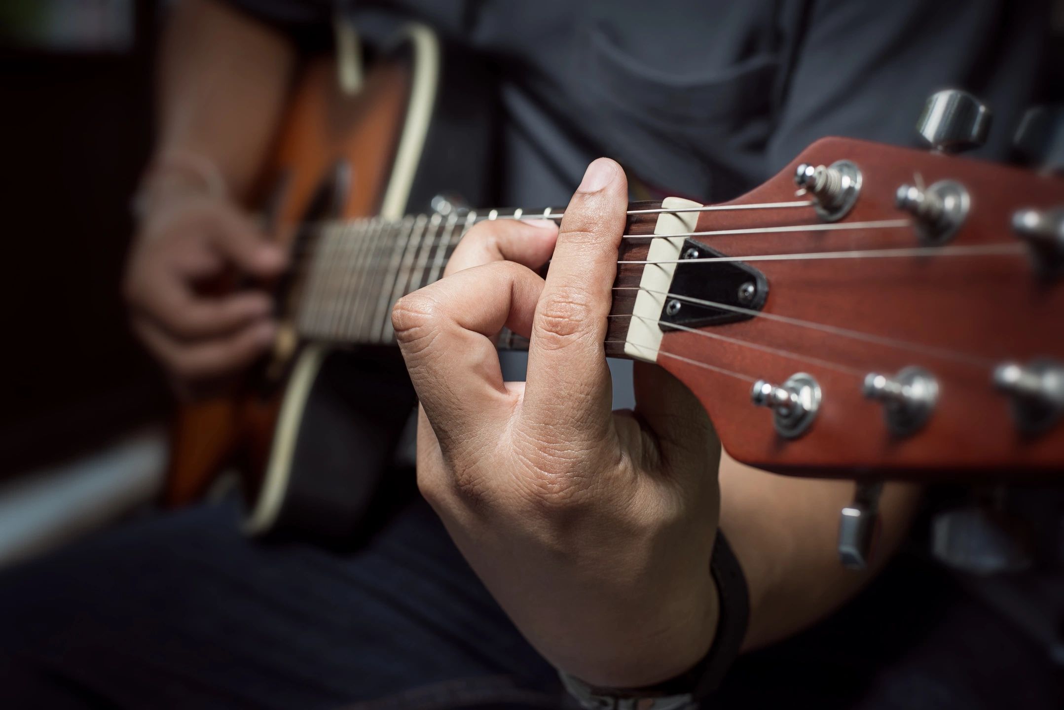 Male guitarist performing live with electric guitar